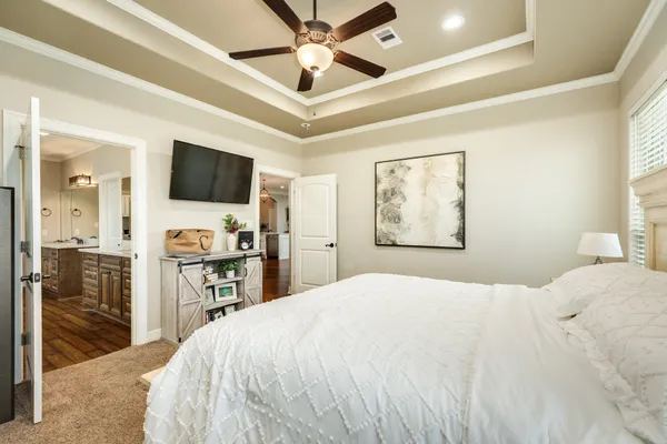 a spacious bathroom with a granite countertop double vanity sink a mirror and a shower