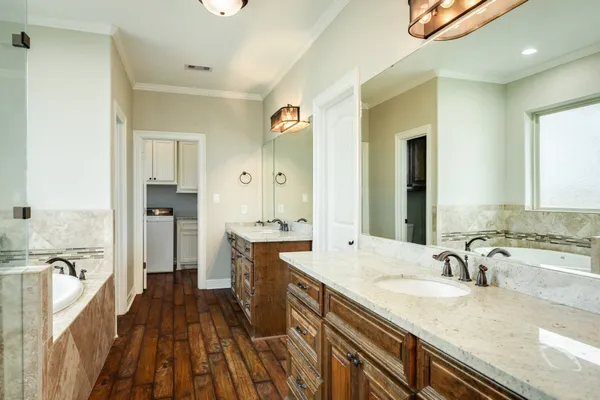 a spacious bathroom with a granite countertop tub sink and mirror