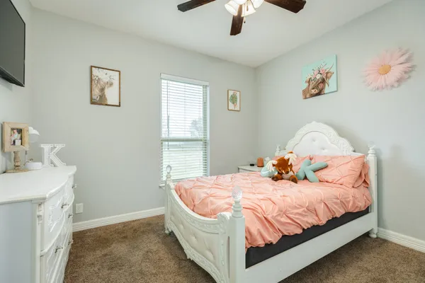 a bed room with a bed window and a flat screen tv