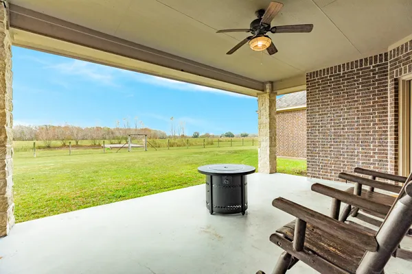 a view of a terrace with a table and chairs