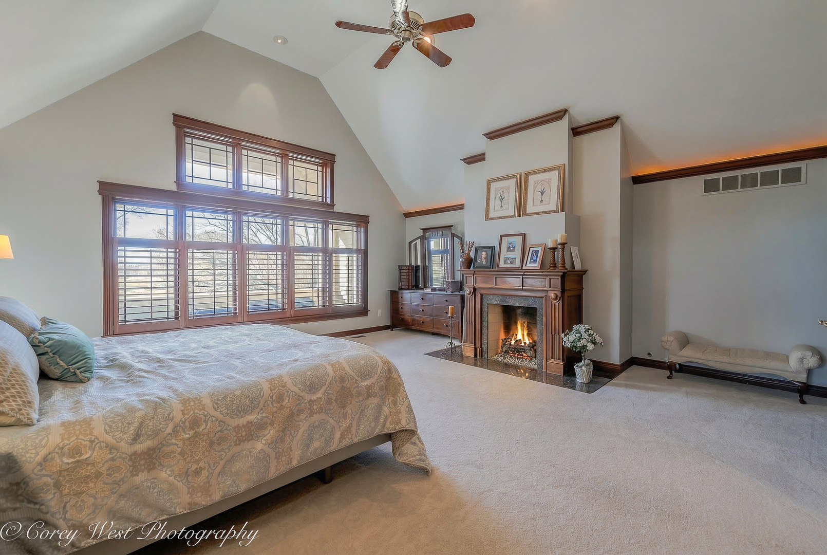 N004 Alexander Drive Geneva, IL 60134 - Photo 30 of 75 a spacious bedroom with a bed and a fireplace