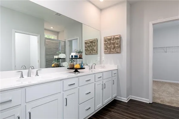 a bathroom with double sink and a mirror