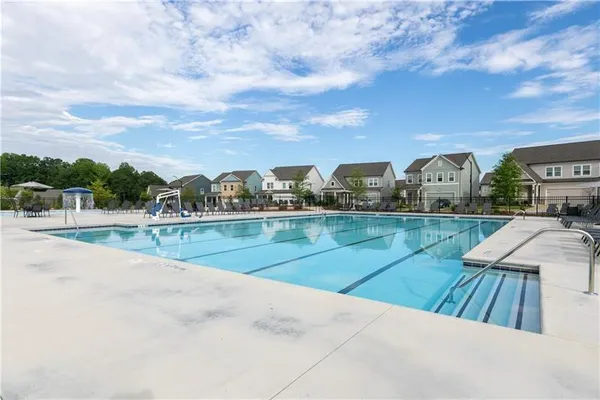 a view of a swimming pool and trees in the background