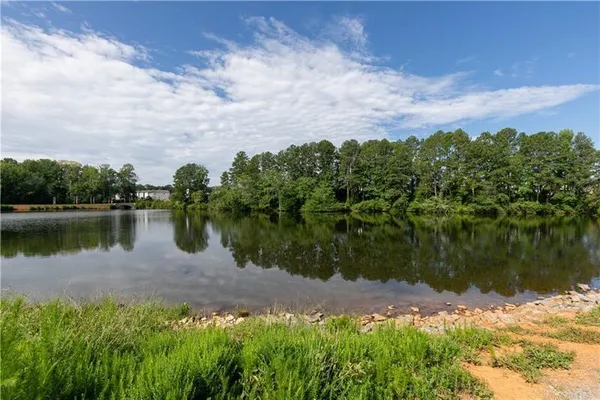 a view of a lake with a house in the background