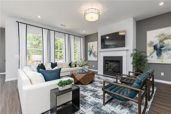 a living room with furniture fireplace and flat screen tv