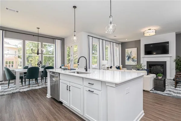 a open kitchen with stainless steel appliances granite countertop a stove and a wooden floors