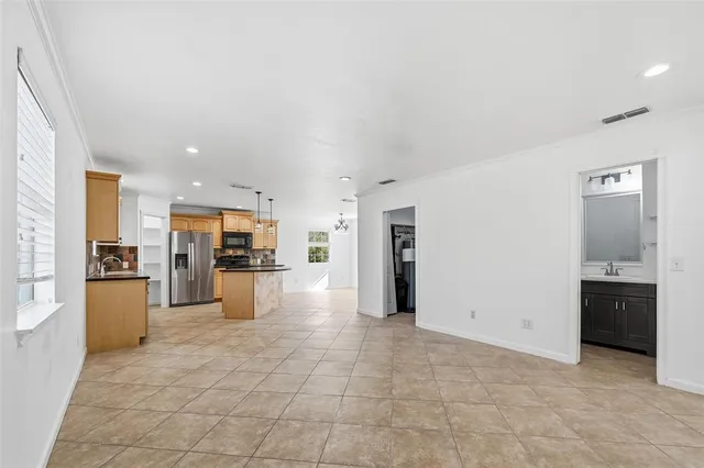 a view of kitchen with refrigerator stove and oven