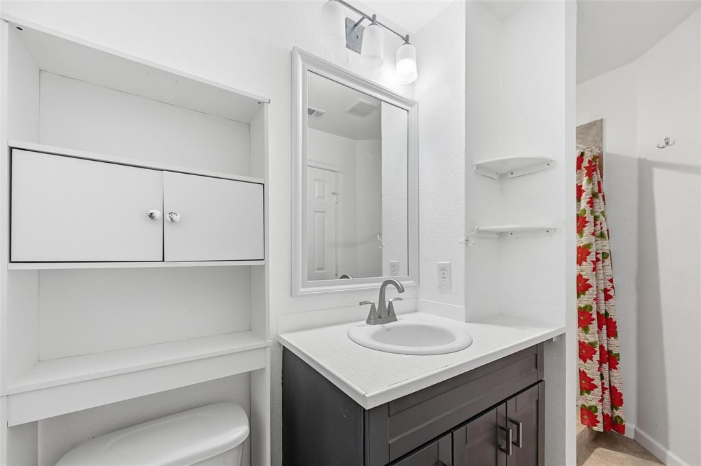 633 Rose Garden Drive, Unit 2 McKinney, TX 75072 - Photo 8 of 17 a bathroom with a sink and a mirror