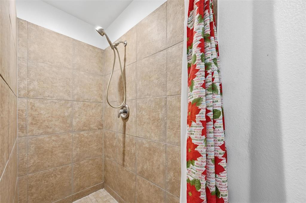 633 Rose Garden Drive, Unit 2 McKinney, TX 75072 - Photo 9 of 17 a bathroom with a shower curtain and curtain