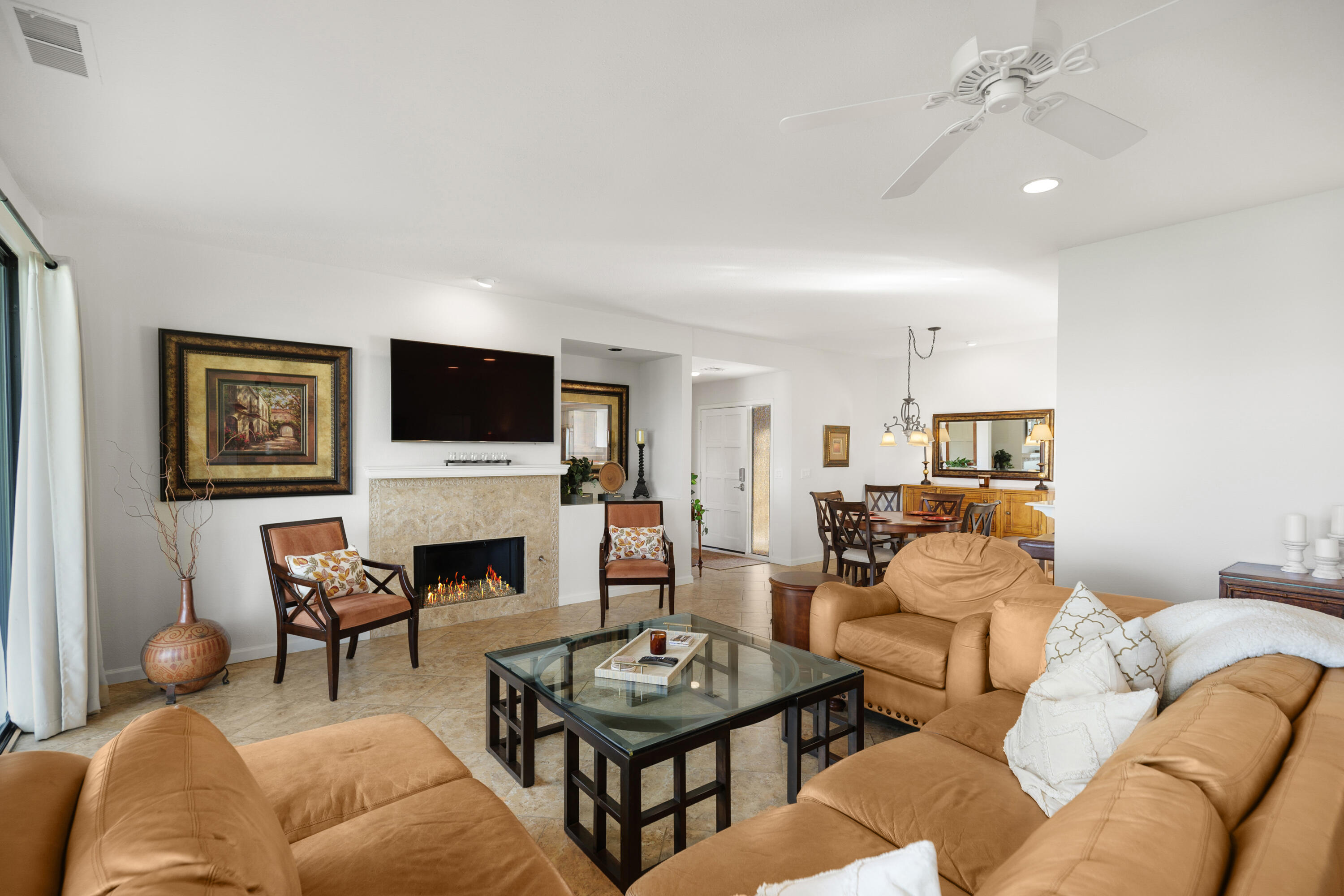 42410 Adams Street Bermuda Dunes, CA 92203 - Photo 11 of 39 a living room with furniture a fireplace and a flat screen tv