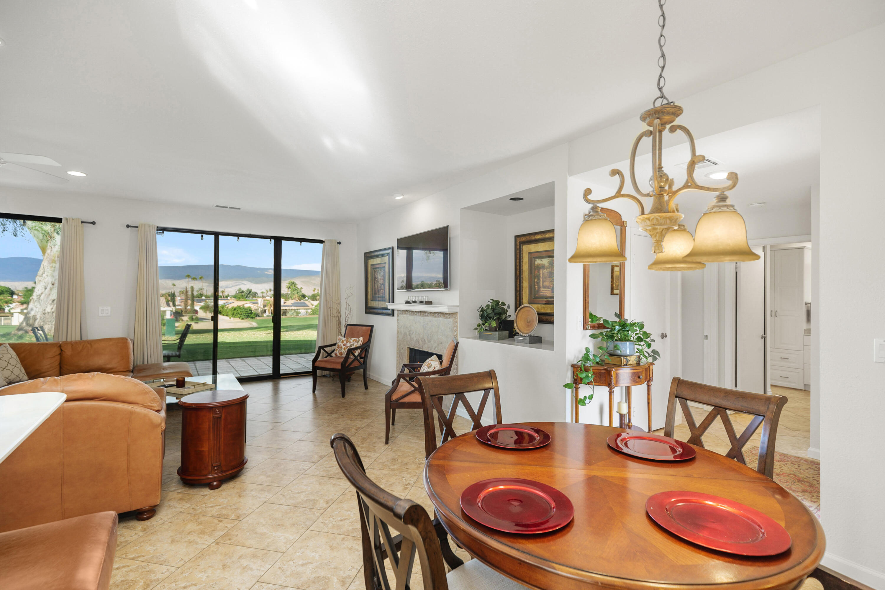 42410 Adams Street Bermuda Dunes, CA 92203 - Photo 15 of 39 a dining room with furniture a large window and a chandelier