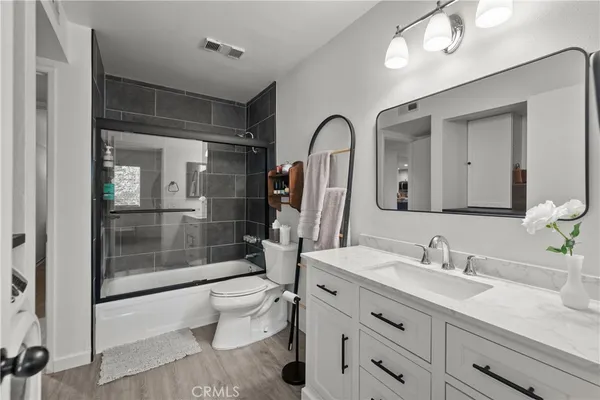 a bathroom with a double vanity sink mirror and toilet