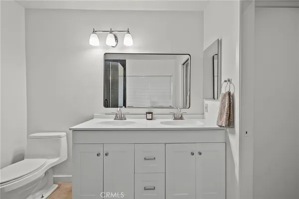 a bathroom with mirror a sink and a toilet