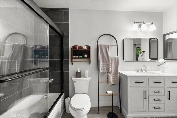 a bathroom with a toilet sink and shower