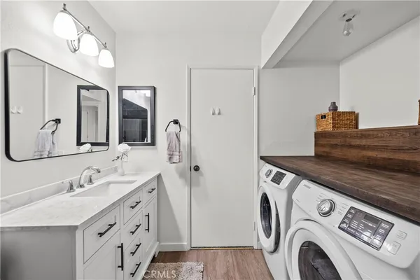 a view of bathroom with a sink a washer and dryer