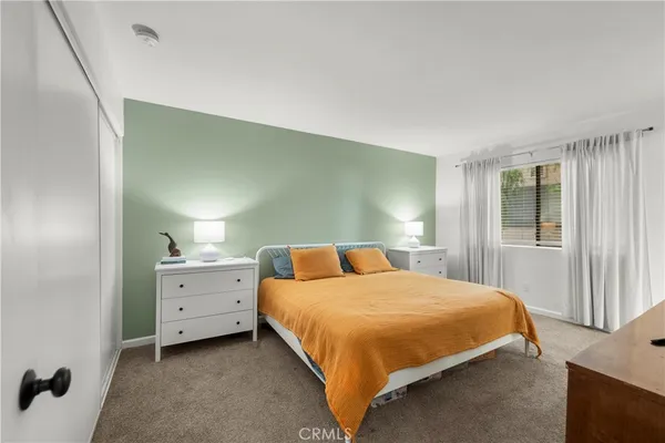 a bedroom with a bed and window