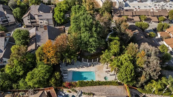 an aerial view of a house with a yard