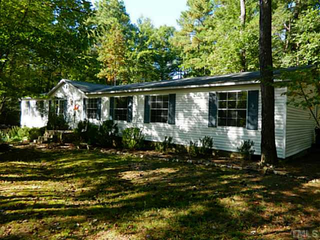 2028 Carpenter Pond Road Raleigh, NC 27613 - Photo 1 of 23 a front view of a house with a yard