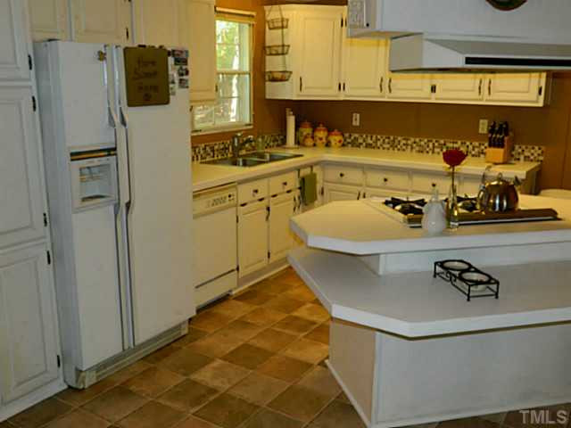 2028 Carpenter Pond Road Raleigh, NC 27613 - Photo 11 of 23 a bathroom with a tub sink and mirror