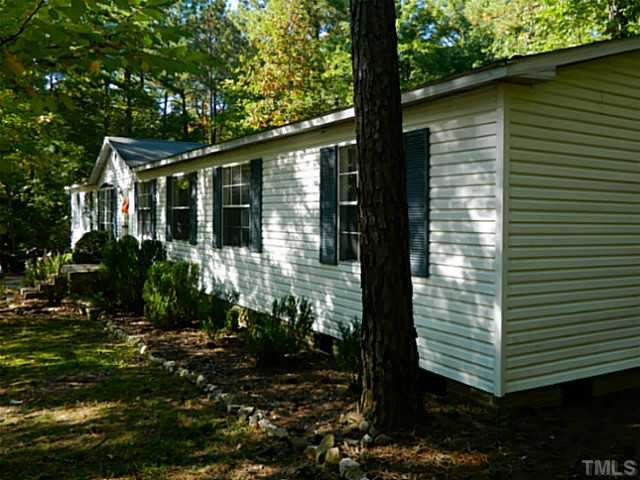 2028 Carpenter Pond Road Raleigh, NC 27613 - Photo 20 of 23 a front view of a house with garden