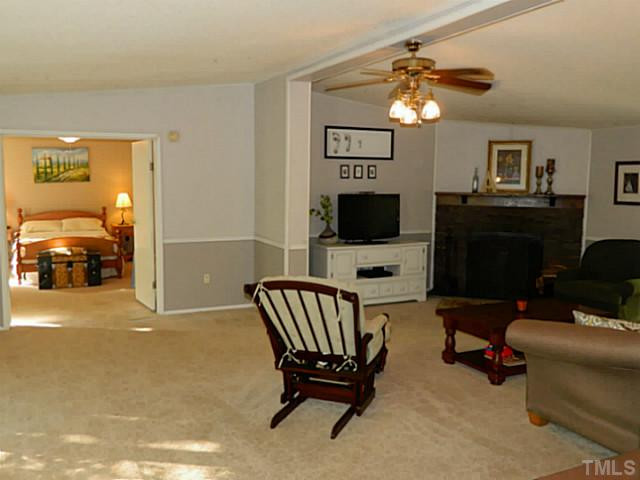 2028 Carpenter Pond Road Raleigh, NC 27613 - Photo 22 of 23 a living room with furniture and a flat screen tv