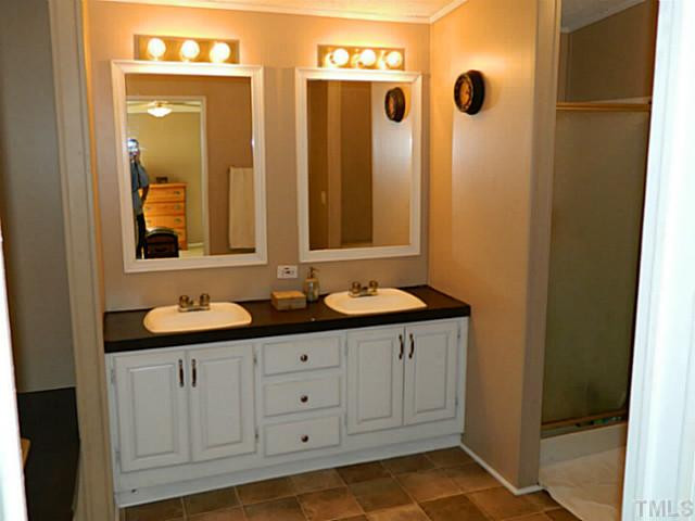 2028 Carpenter Pond Road Raleigh, NC 27613 - Photo 5 of 23 a bathroom with a sink and a mirror