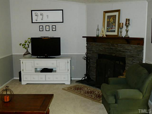 2028 Carpenter Pond Road Raleigh, NC 27613 - Photo 8 of 23 a living room with furniture and a fireplace