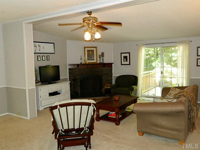 2028 Carpenter Pond Road Raleigh, NC 27613 - Photo 9 of 23 a living room with furniture and a flat screen tv