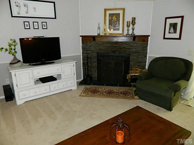 2028 Carpenter Pond Road Raleigh, NC 27613 - Photo 10 of 23 a living room with furniture and a flat screen tv