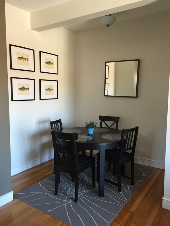 15 Ellery Street, Unit 11 Cambridge, MA 02138 - Photo 5 of 10 a view of a dining room with furniture and wooden floor