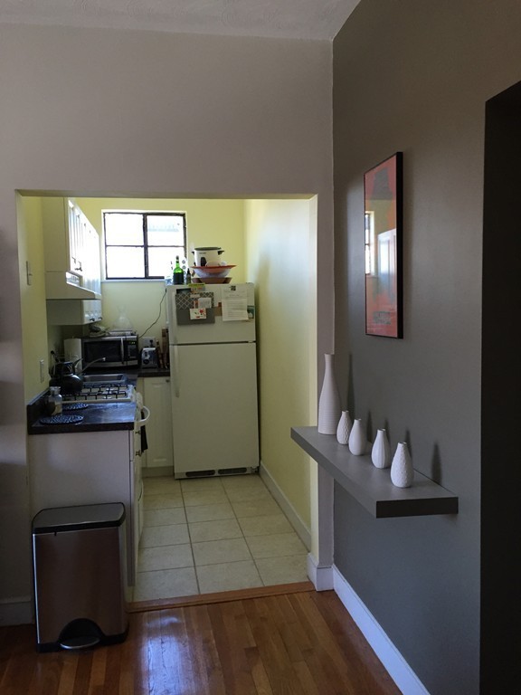 15 Ellery Street, Unit 11 Cambridge, MA 02138 - Photo 6 of 10 a kitchen with a refrigerator and a stove top oven