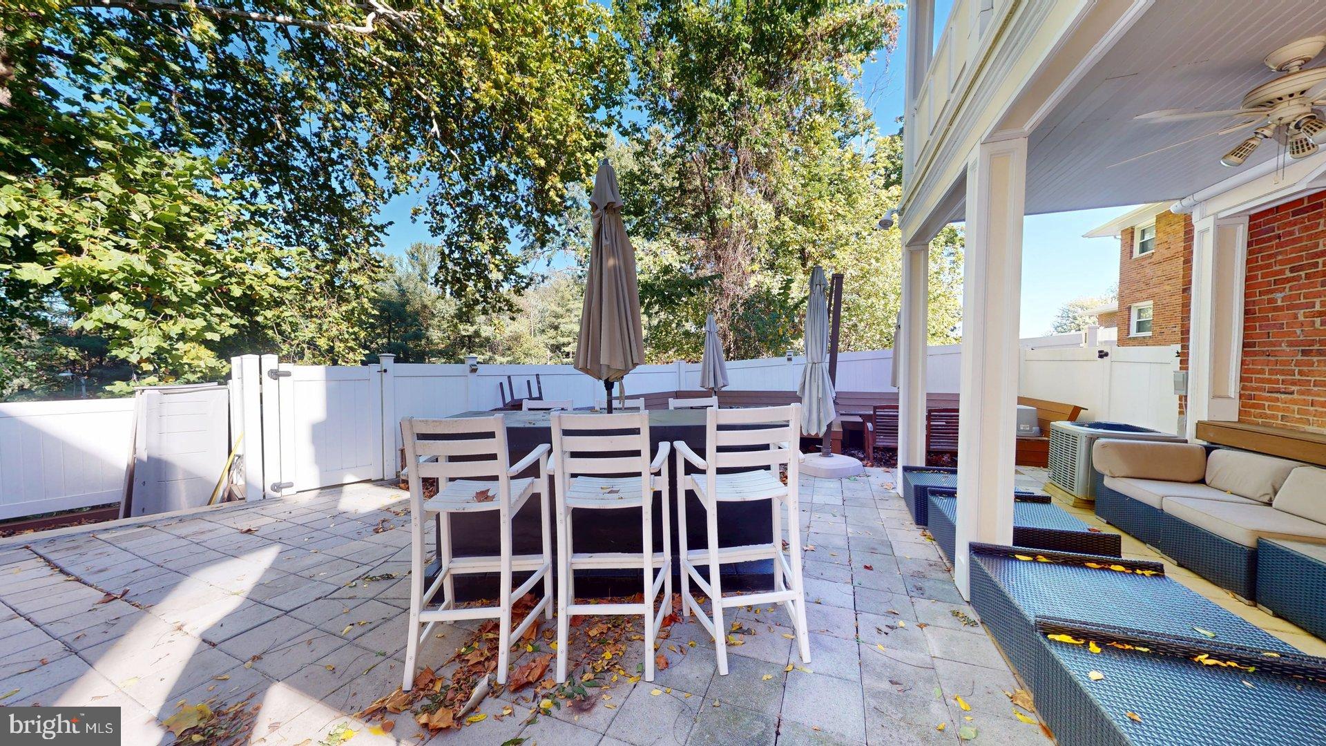 4145 21st Road North, Unit B Arlington, VA 22207 - Photo 28 of 29 a view of a patio with table and chairs and floor to ceiling window