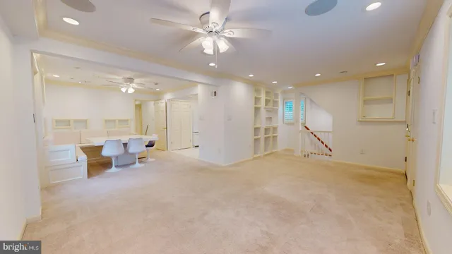 a view of a big room with kitchen and windows