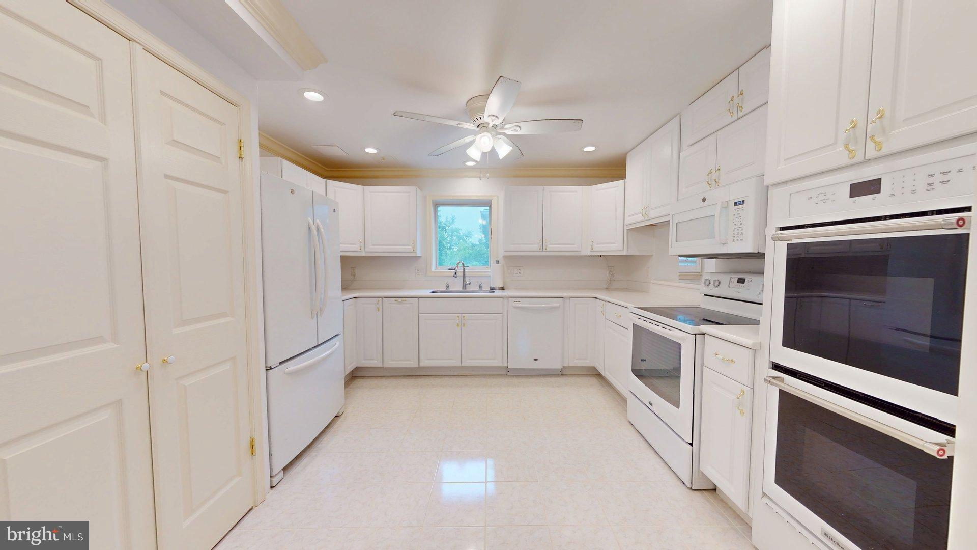 4145 21st Road North, Unit B Arlington, VA 22207 - Photo 9 of 29 a kitchen with white cabinets and white appliances