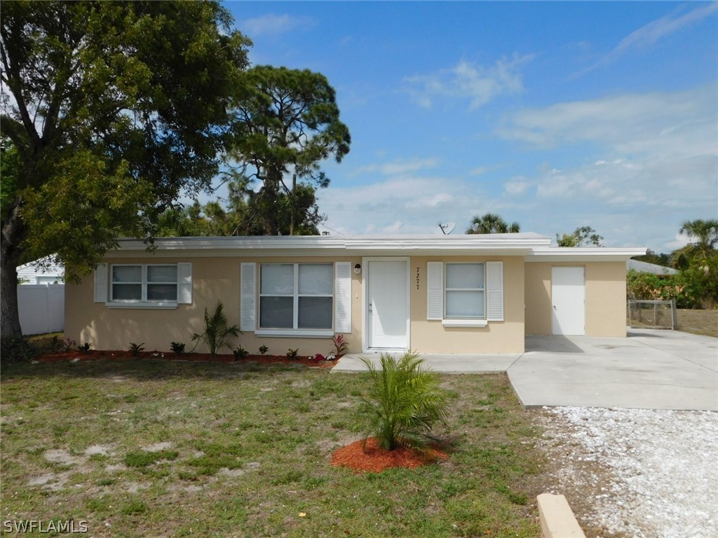 7277 Myrtle Road Fort Myers, FL 33967 - Photo 1 of 17 front view of a house with a yard
