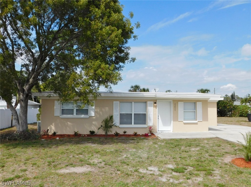 7277 Myrtle Road Fort Myers, FL 33967 - Photo 17 of 17 a backyard of a house with yard and outdoor seating
