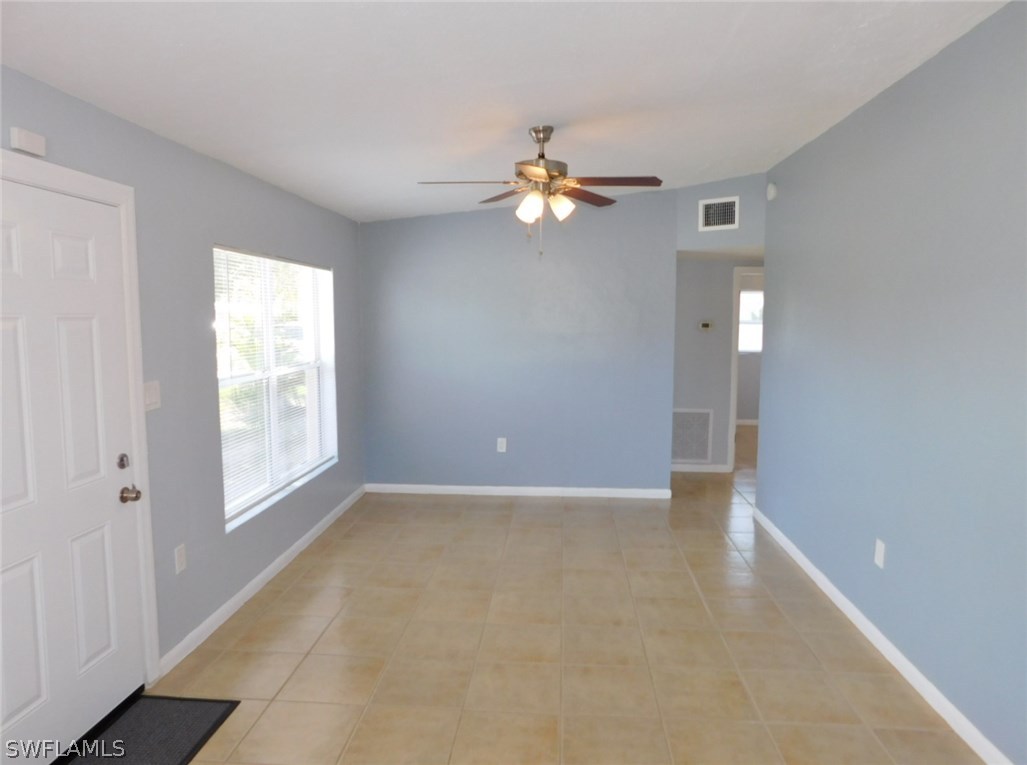 7277 Myrtle Road Fort Myers, FL 33967 - Photo 3 of 17 wooden floor in an empty room with a window