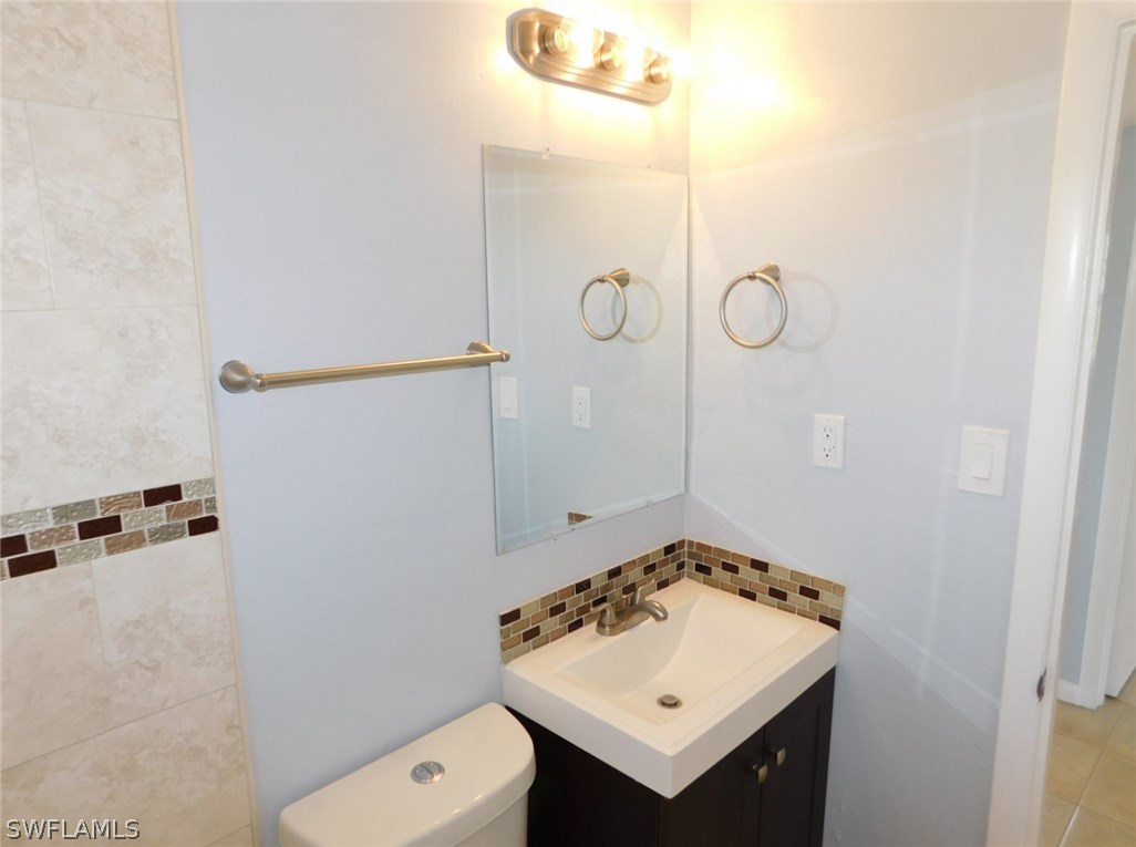7277 Myrtle Road Fort Myers, FL 33967 - Photo 6 of 17 a bathroom with a sink a toilet and shower