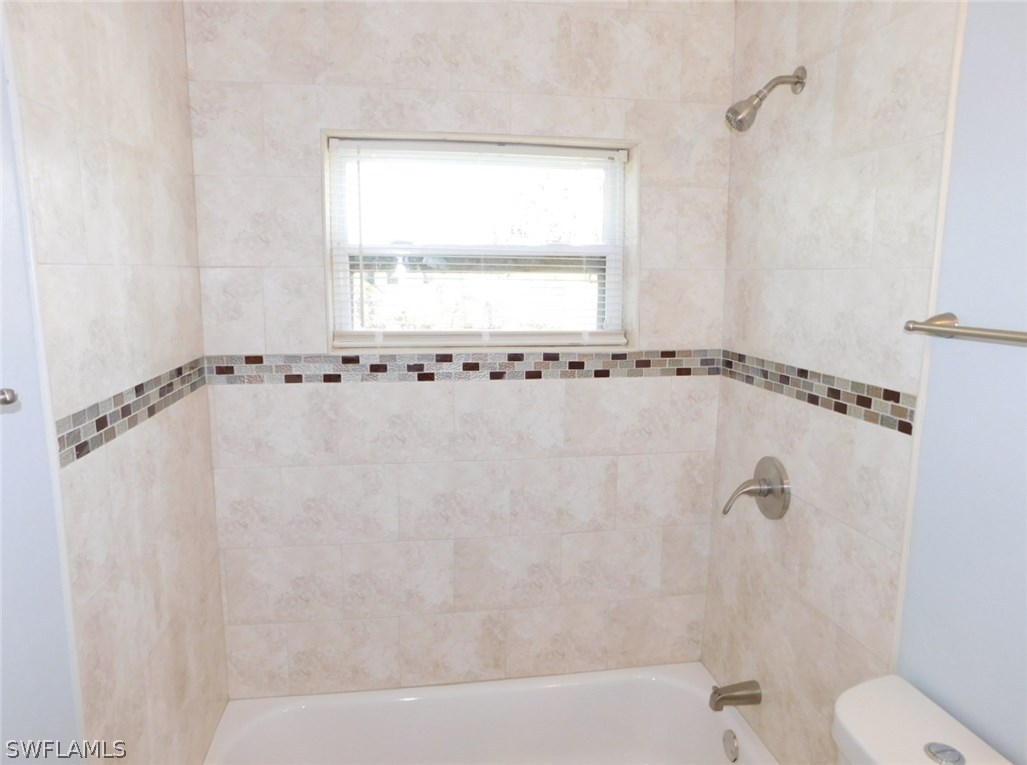 7277 Myrtle Road Fort Myers, FL 33967 - Photo 8 of 17 a bathroom with a bathtub and a shower