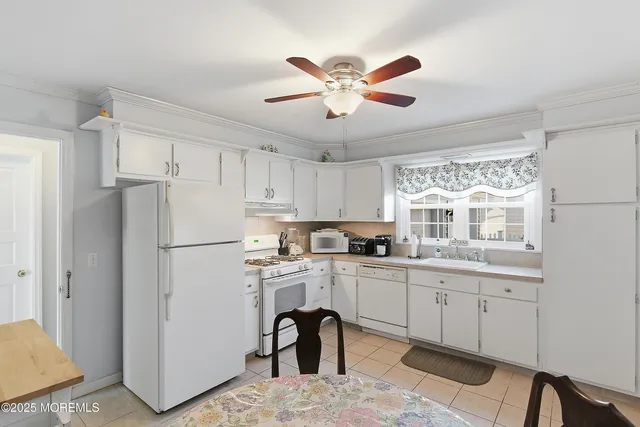 a living room with furniture a flat screen tv and a floor to ceiling window