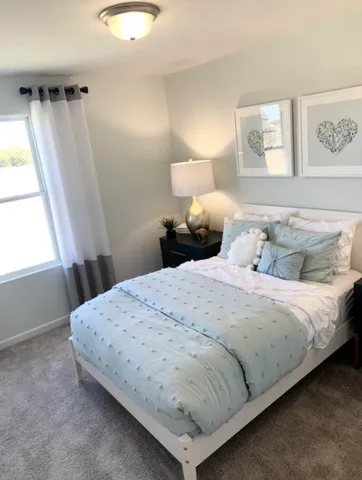 a bedroom with a bed and a window