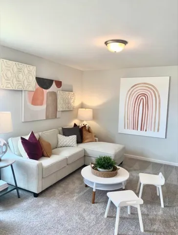 a living room with furniture and a potted plant