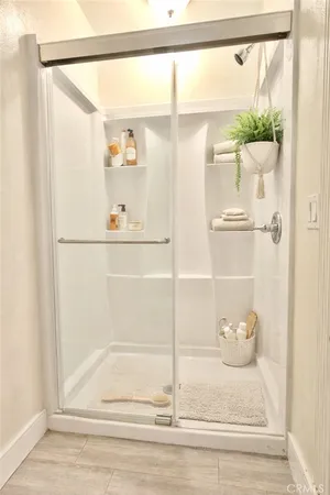 a bathroom with a glass shower door