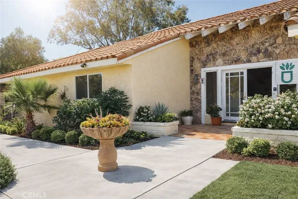 a front view of a house with a yard garage and outdoor seating