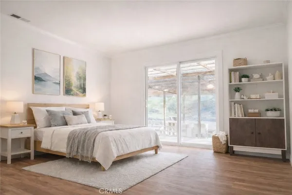 a bedroom with a bed and a large window