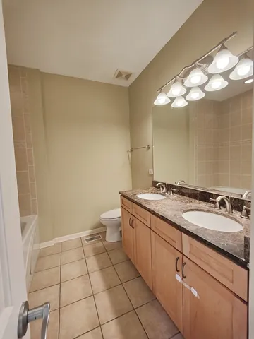 a spacious bathroom with a double vanity sink and a mirror