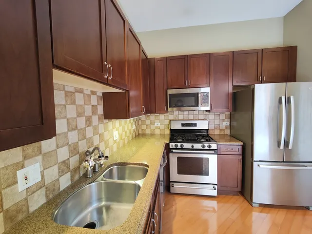 a kitchen with a sink a stove and refrigerator