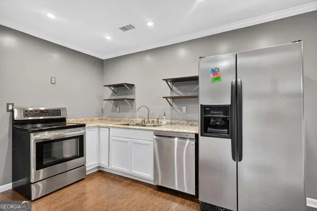 a view of kitchen with furniture and wooden floor