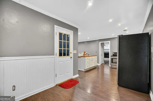 a view of an empty room with a window and a ceiling fan