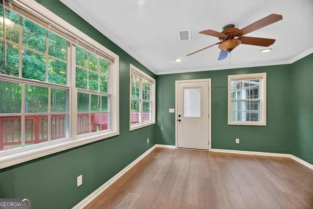 a view of wooden floor and windows in a room